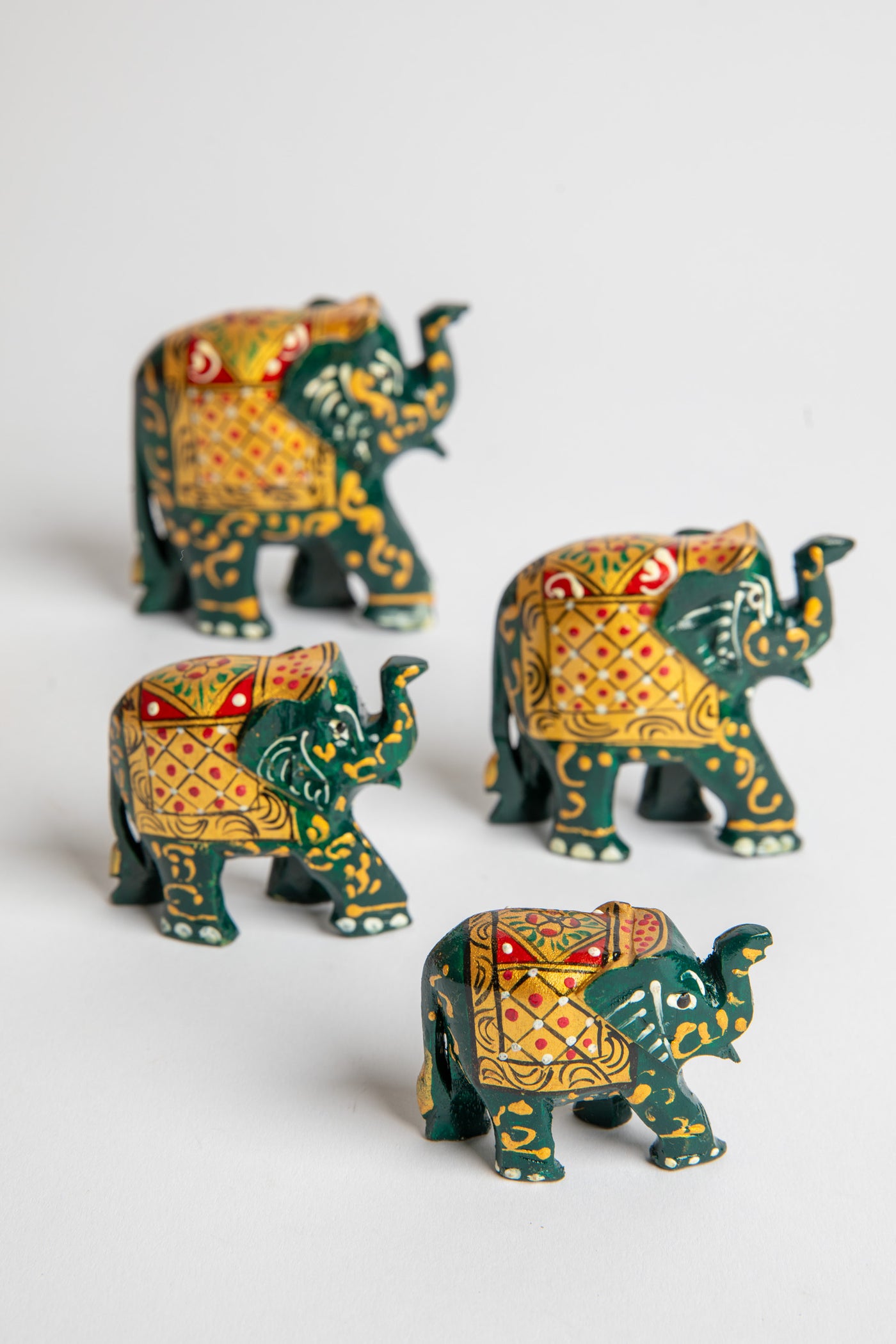 Wooden hand painted elephant family in green