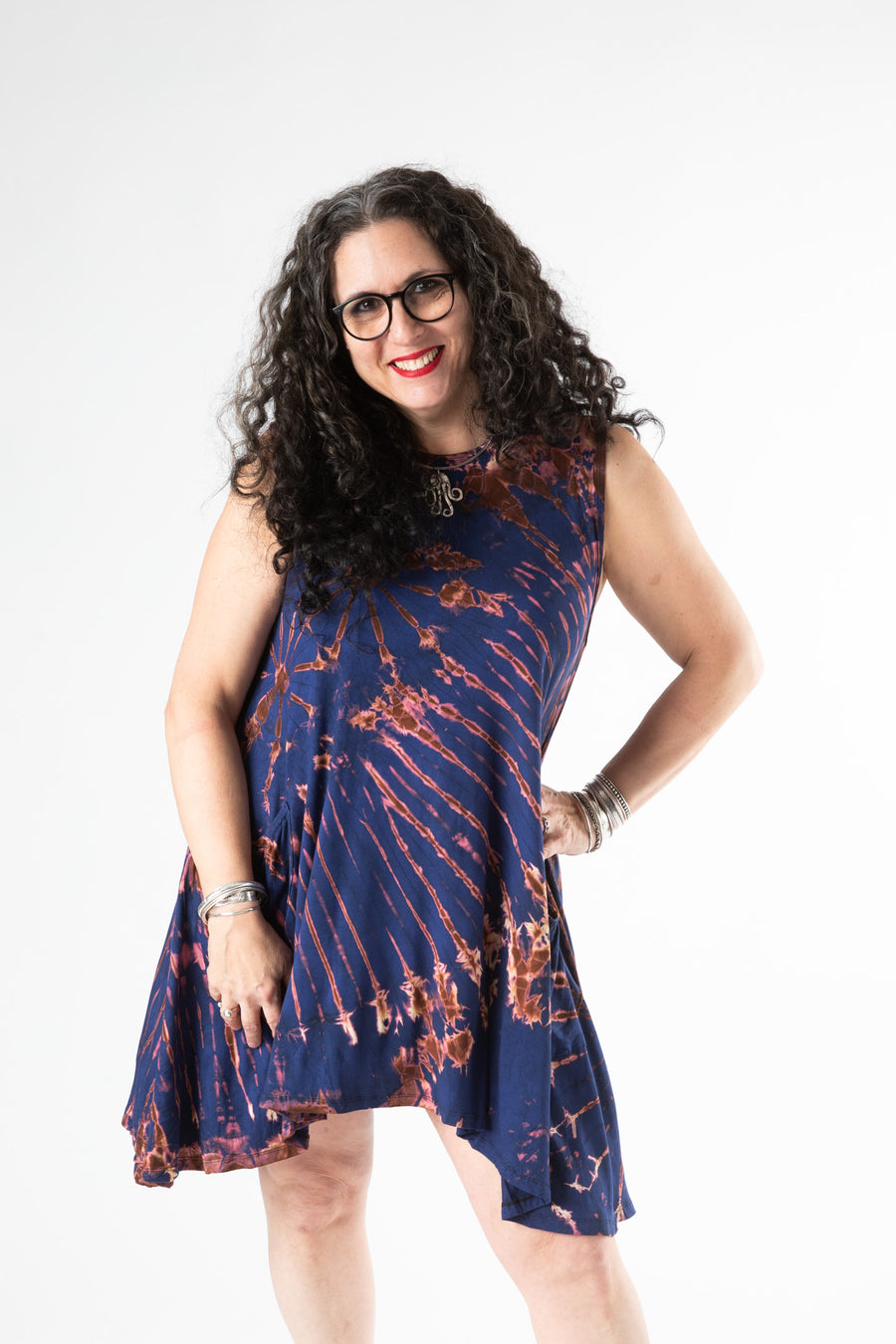 Happy boho woman wearing a blue die dye tank top dress and sterling silver bracelets 