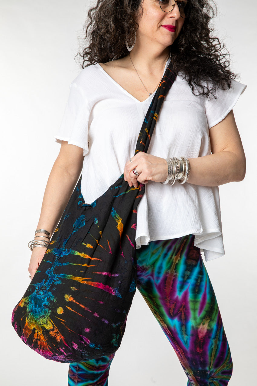 Susan is wearing a tie dye bag in black rainbow