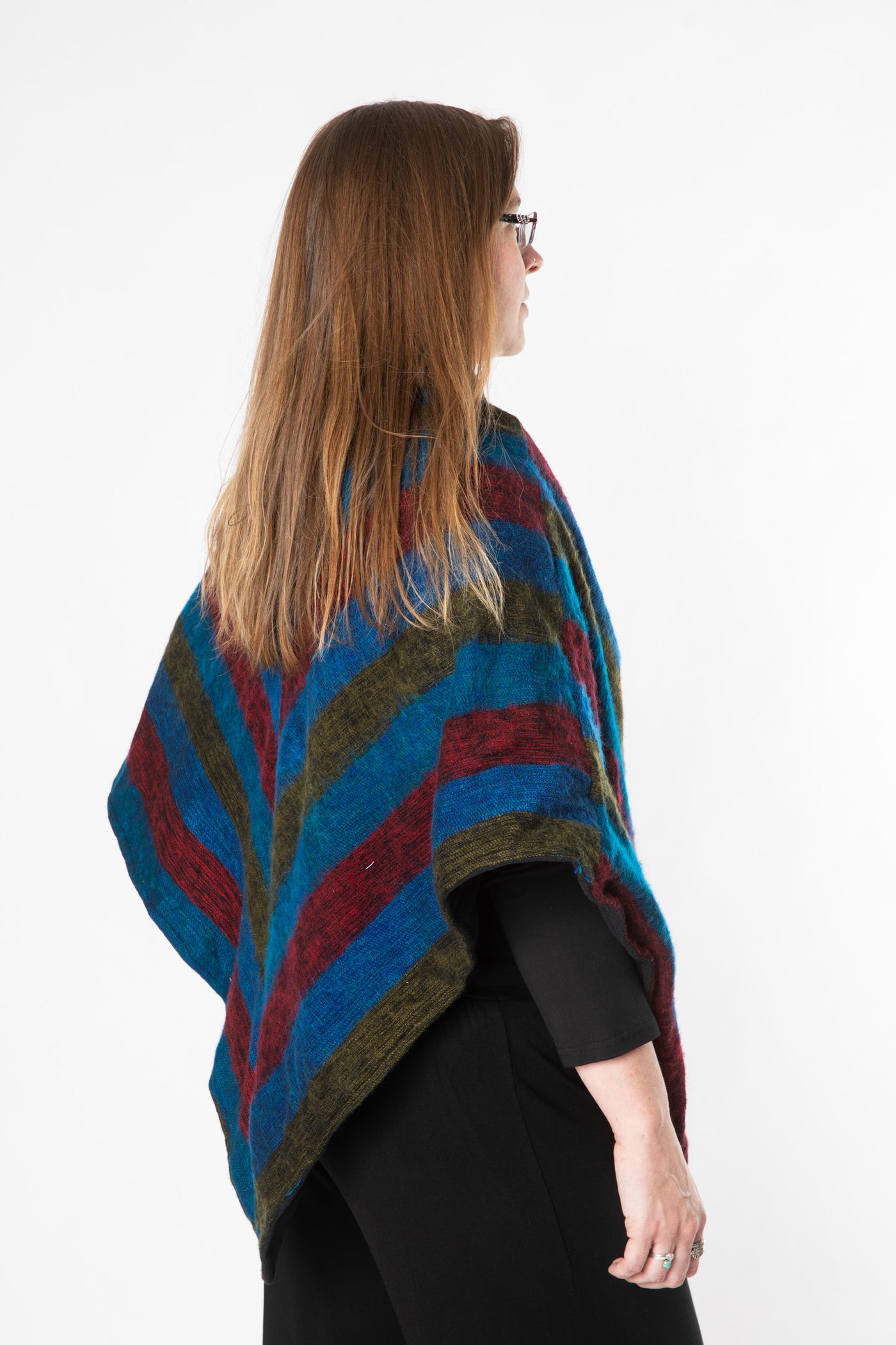 Margaret is wearing a fleece lined poncho in multicolor