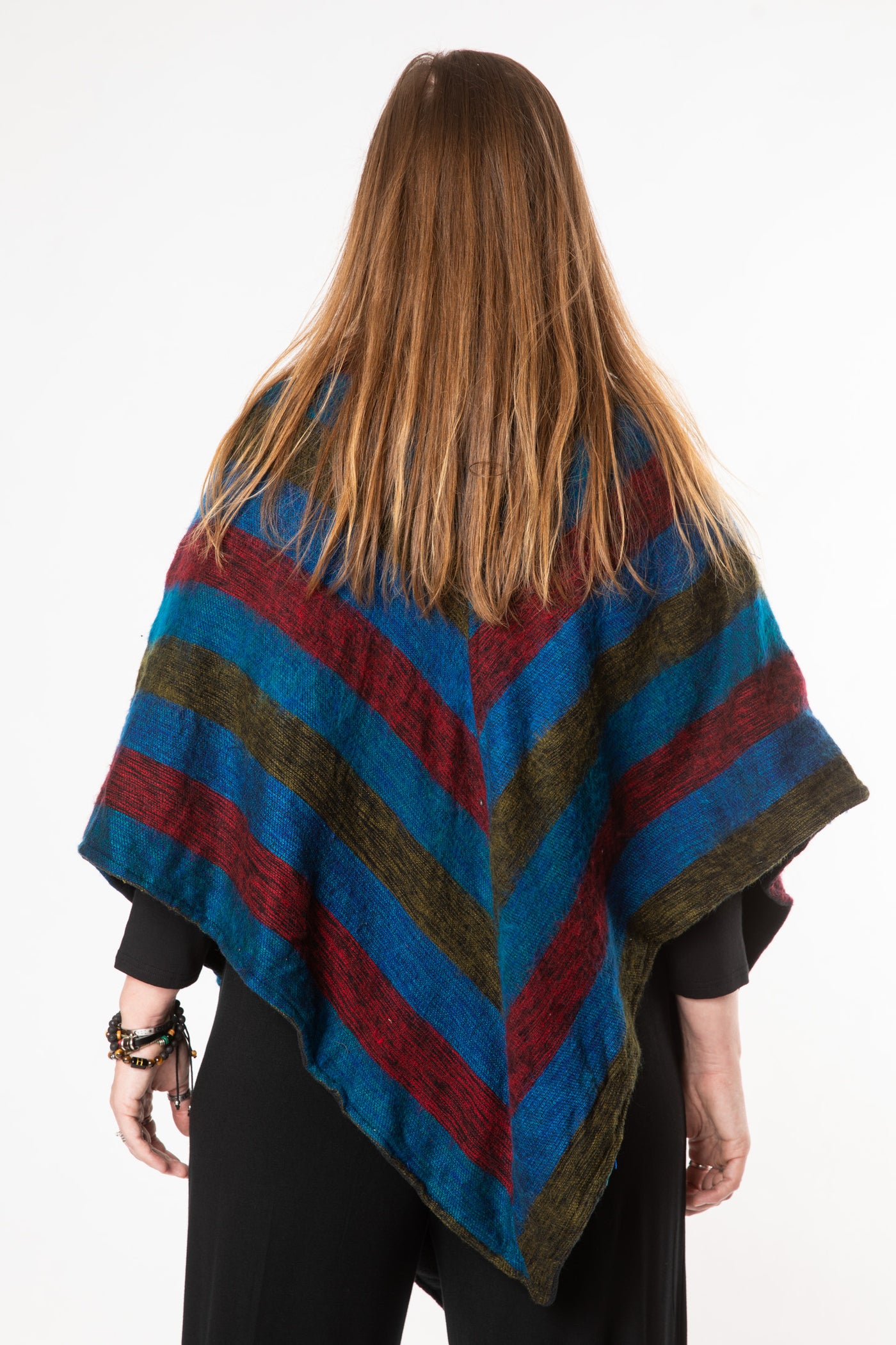 Margaret is wearing a fleece lined poncho in multicolor