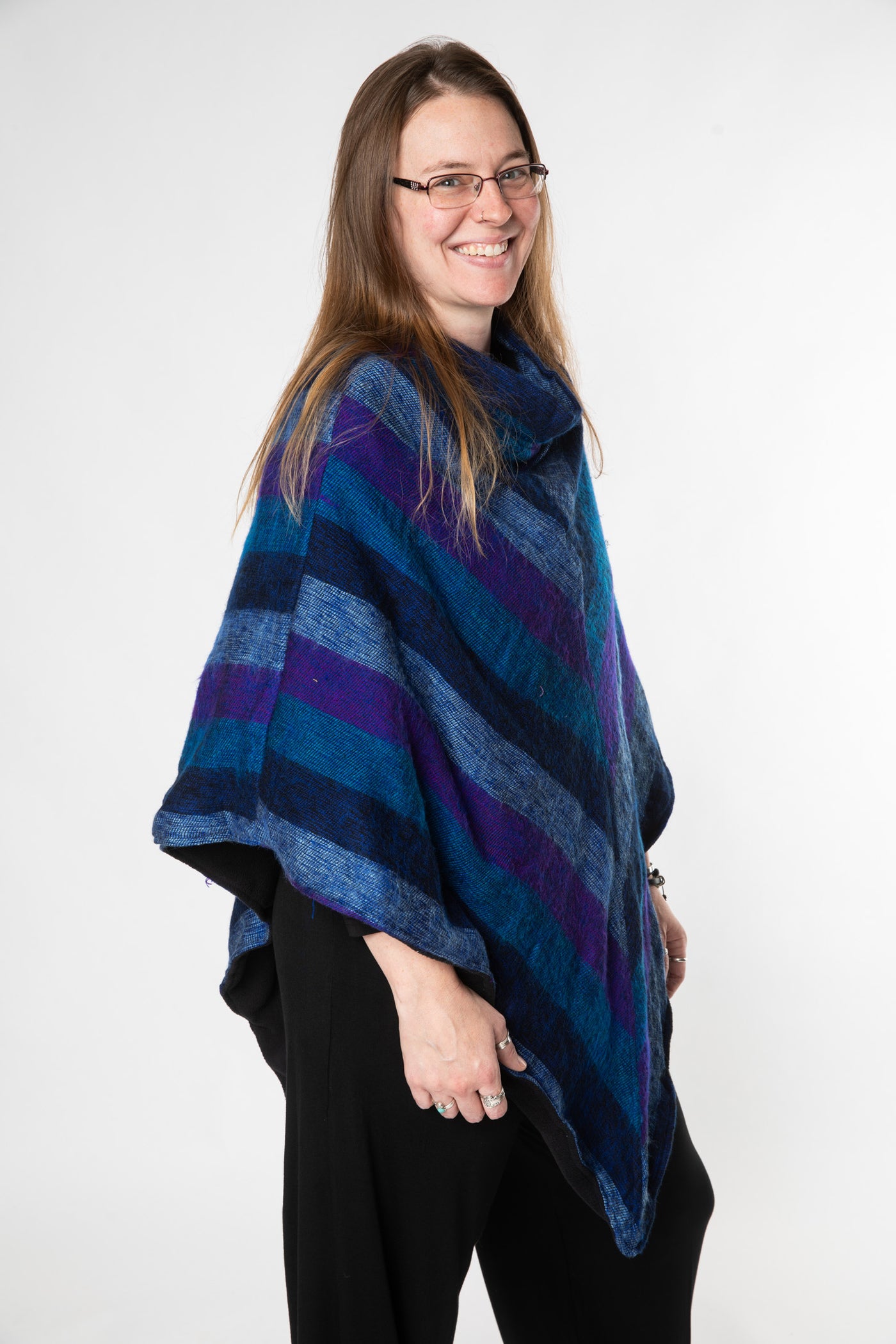 Margaret is wearing a fleece lined poncho in purple