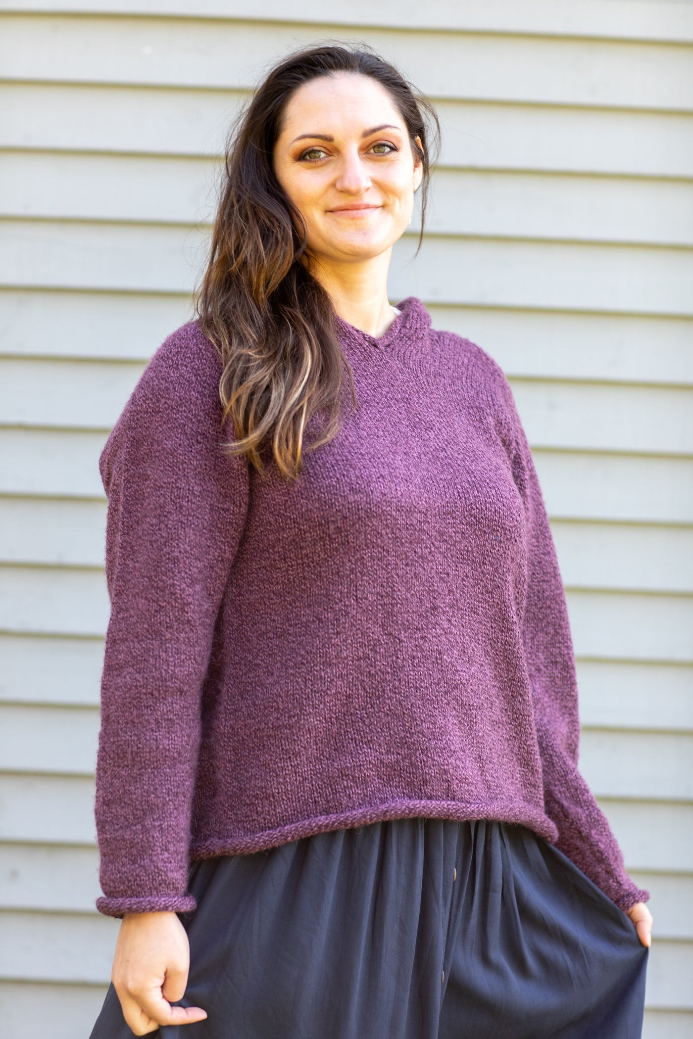 Morgaine is wearing size M alpaca hoodie in plum